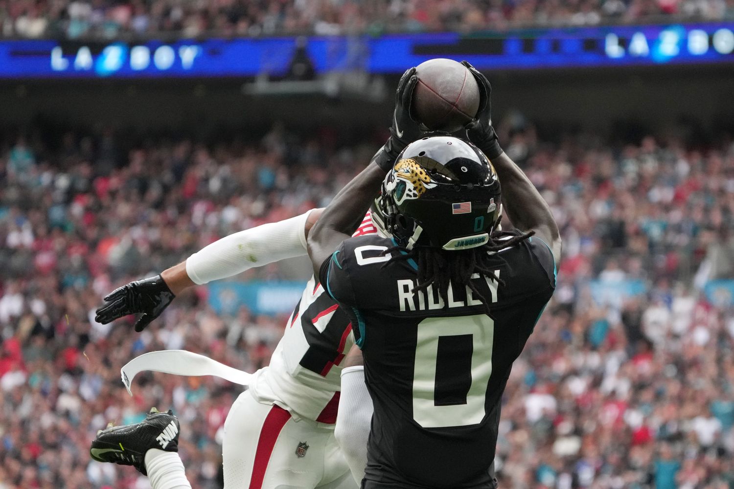 Jacksonville Jaguars wide receiver Calvin Ridley (0) catches a 39-yard touchdown pass against Atlanta Falcons cornerback A.J. Terrell (24) in the first half during an NFL International Series game at Wembley Stadium.